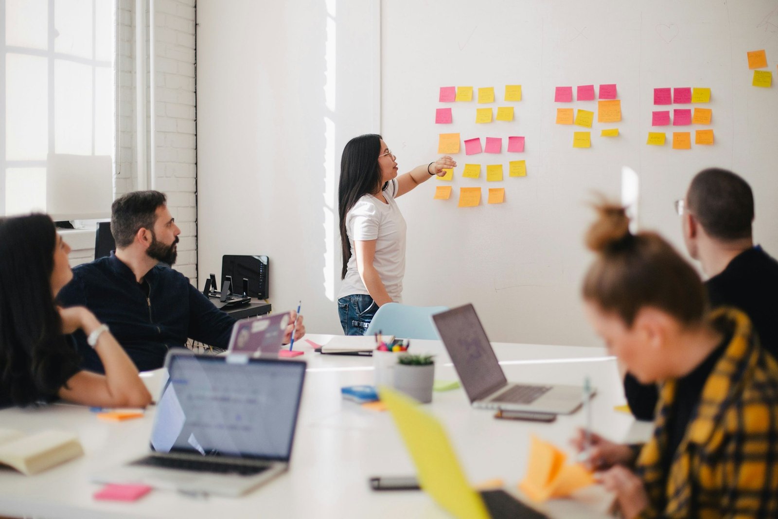 A team mapping out a project plan on a whiteboard during a sprint planning session