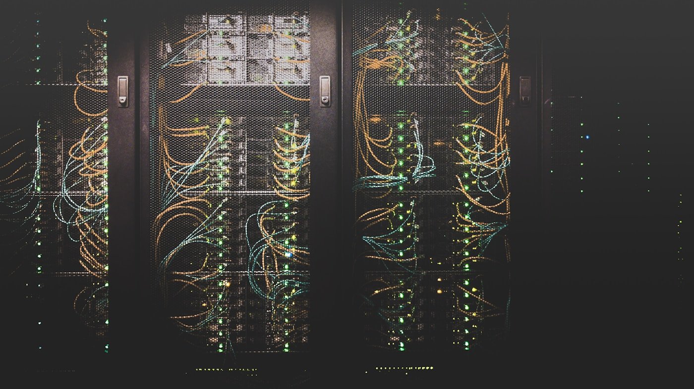 Server racks in a data center with illuminated network cabling